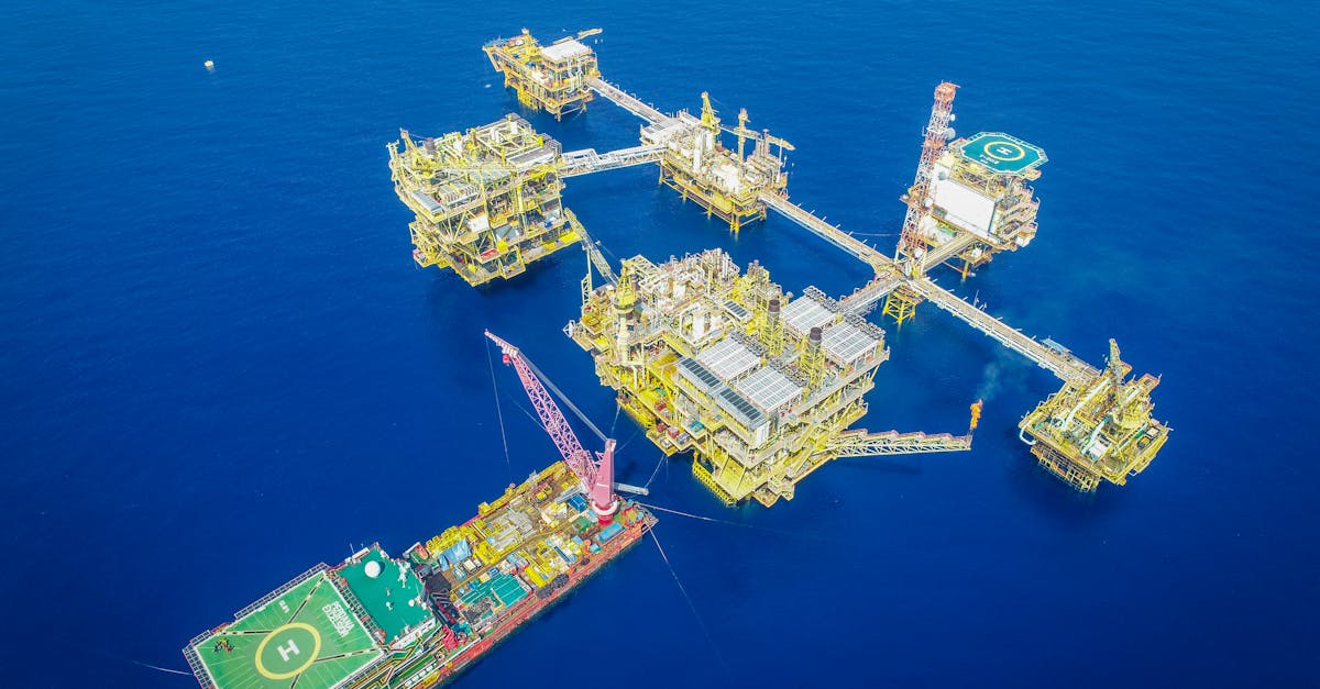 Aerial shot of an offshore oil platform complex in the ocean, showcasing industrial infrastructure.